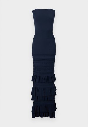 Rochie maxi bleumarin, strâmtă, fără mâneci, cu bust texturat, modele complexe din dantelă și volane suprapuse la tivul fustei.