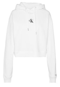 Witte crop hoodie van zachte stof met een capuchon met trekkoord, geribbelde manchetten en een klein zwart "ck" logo op de voorkant.