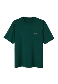 T-shirt vert foncé à manches courtes avec col rond et petit texte blanc "LUTIN RÂLEUR" sur le côté gauche de la poitrine.