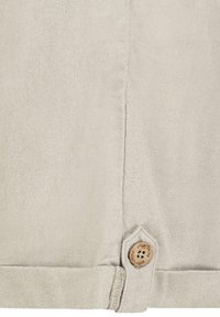 Light beige linen fabric with a textured finish, featuring a decorative wooden button and stitched hem detail.