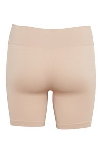 Seamless beige high-waist biker shorts with a wide waistband, designed for a smooth, snug fit.