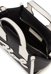 Black textured leather handbag with white accents, featuring a top zipper closure, two short handles, and a logo detail on the front.