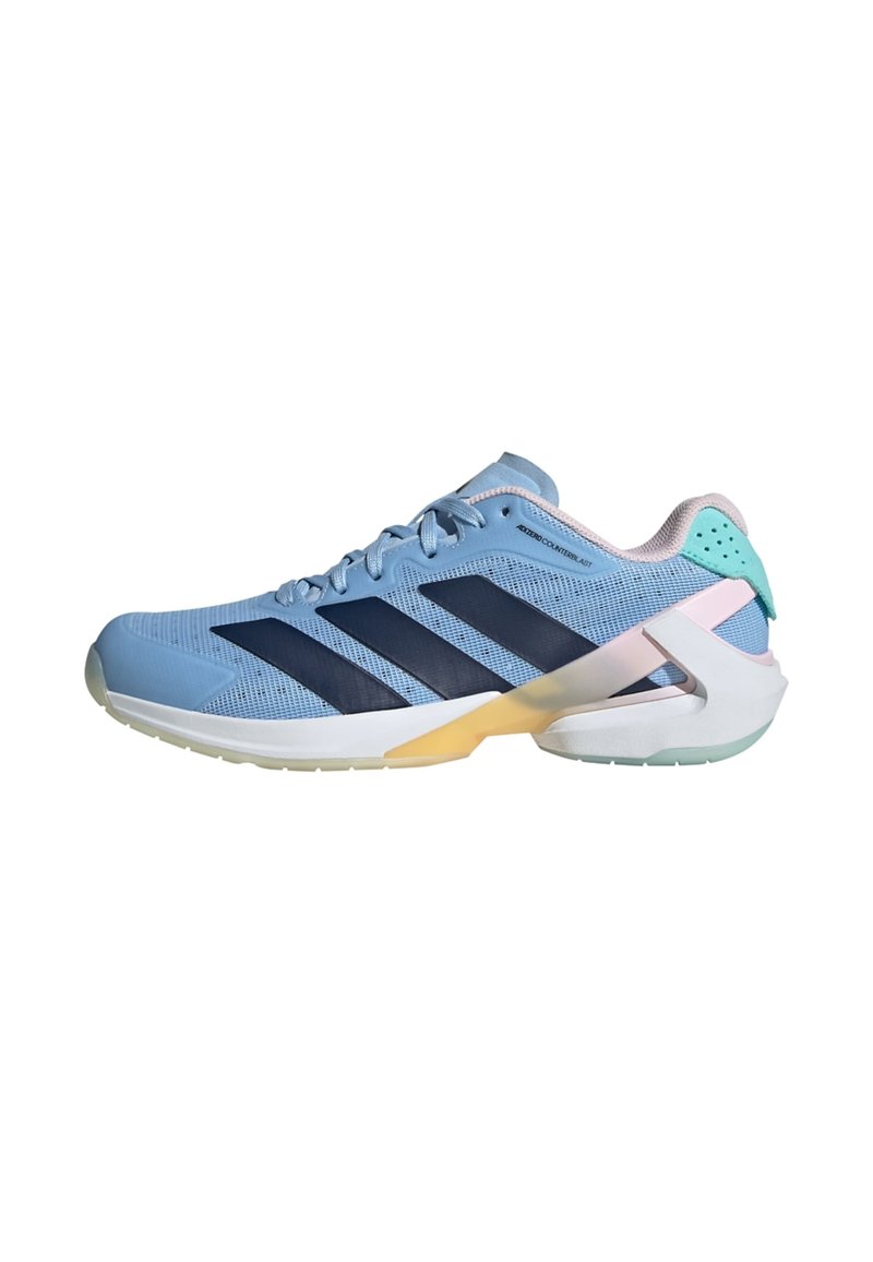 Light blue athletic shoe with navy stripes, mesh upper, padded collar, and a translucent sole featuring a yellow accent and a mint green heel.
