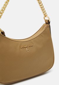 Tan nylon skuldertaske med lynlås i toppen, guldfarvet kædetræk og "Michael Kors"-logo prægede på forsiden. Glat tekstur.
