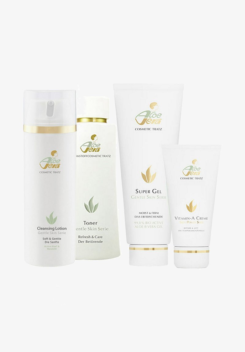 Four skincare products in white containers: Cleansing Lotion, Toner, Super Gel, and Vitamin-A Creme. Labels feature green and gold accents.