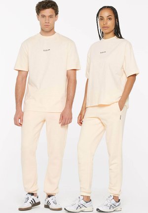 LE-ON JOGGING UNISEX - Tracksuit bottoms - cream
