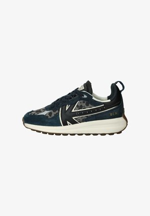 Navy blue and gray sneaker with suede and patterned fabric, black accents, white sole, and "BCN" printed on the heel.