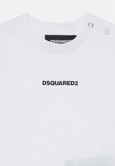 White cotton t-shirt featuring a round neckline, silver snap details, and a black "DSQUARED2" logo printed at the center.