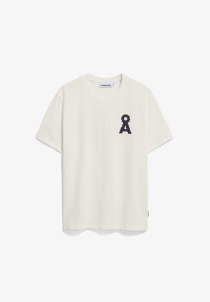 White cotton t-shirt with short sleeves and a round neckline. Features a textured black ribbon-like design on the left chest.