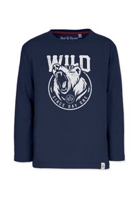 Laadukkaita sininen pitkähihaista T-paitaa, jossa on valkoinen karhukuva ja tekstit "WILD" ja "SINCE DAY ONE". Pehmeää puuvillakangasta, pyöreä pääntie, tarralappu helma.