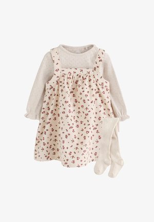 Top texturizado crema de manga larga con vestido peto floral a juego y medias de canalé crema para bebé o niño pequeño.