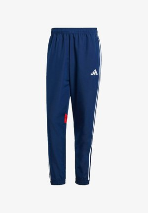 Marineblauwe sportbroek met een te trekken tailleband, witte zijstrepen en een rode accent bij de zoom. Gemaakt van een lichtgewicht, soepel materiaal.