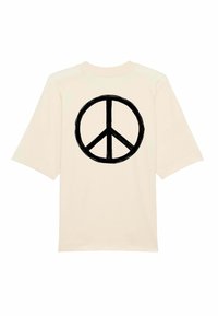 Kermakeltainen oversized t-paita, jossa on suuri musta rauhanmerkki selässä. Lyhyet hihat ja pehmeä puuvillamateriaali.