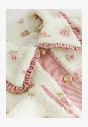 Floral-patterned fleece jacket with a cream base and pink ruffled collar. Features pink ribbed placket and round buttons. Soft texture.