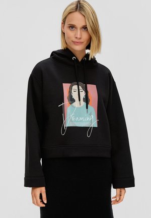 Black hooded sweatshirt with a cropped design. Features a front graphic of a woman with text “Dreaming” in white, with pastel background accents.