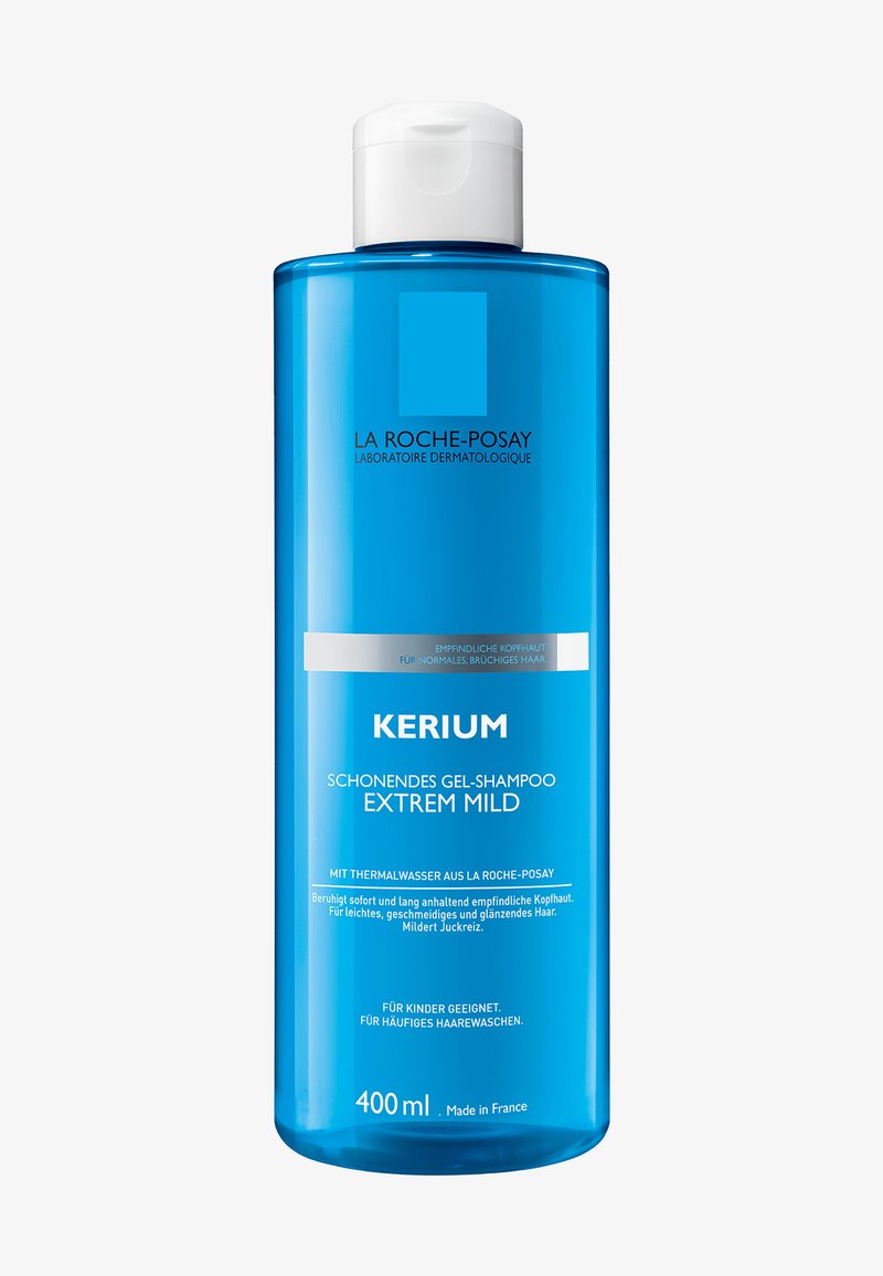 Transparent blue plastic bottle of Kerium gel shampoo with a white flip-top cap. Contains 400 ml. Features black and white text labels.