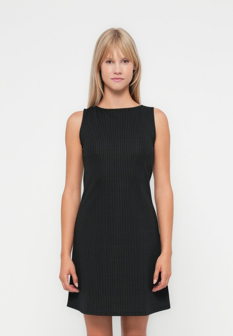 Black sleeveless dress made of ribbed fabric, featuring a round neckline and a fitted design that flares slightly at the hem.