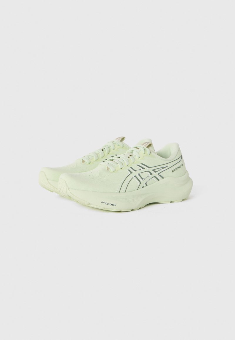 Light green athletic shoes with a textured upper, patterned design on the sides, and a thick sole. Laces and subtle branding accents included.