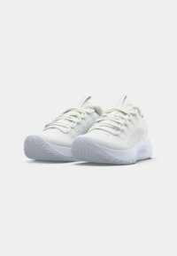 White athletic shoes with a textured knit upper, elastic laces, and a cushioned sole featuring a translucent rubber tread.