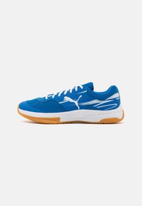 Blue athletic shoes with mesh upper, white laces, and a rubber sole. Features a distinctive logo and textured patterns on the side.
