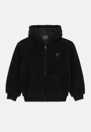 Veste à capuche noire en polaire texturée, douce au toucher. Elle dispose d'une fermeture éclair à l'avant, de deux poches avant et d'un accent en forme de triangle sur la poitrine.