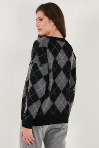 Maglione lavorato a maglia con un motivo argyle nero e grigio, caratterizzato da un collo rotondo e polsini a costina, mostrato da una vista laterale.