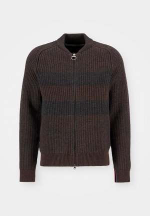 Dark brown ribbed knit cardigan with zip closure, featuring contrasting dark gray horizontal stripes and a red, white, and blue accent at the sleeve.