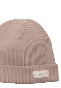 Beige ribbed knit beanie with a folded cuff and a fabric label reading "oh happy day." Smooth texture, semi-structured shape.