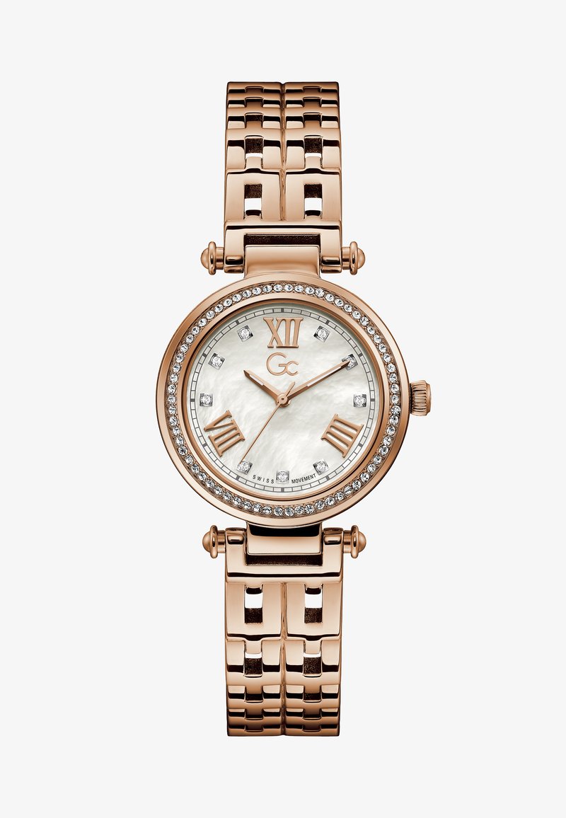 Złoty różowy zegarek z okrągłą kopertą, tarczą z masy perłowej, rzymskimi cyframi, kryształowymi akcentami i bransoletą na ogniwa.