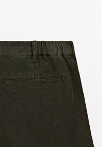 Dark green, textured fabric pants with an elastic waistband and a back pocket. Simple design, soft linen-like material.