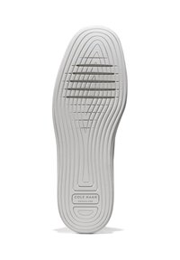 Suola di scarpa in gomma bianca con scanalature testurizzate e un logo centrale che recita "COLE HAAN GRAND.360". Presenta bordi lisci e curvi e diversi modelli di linee.