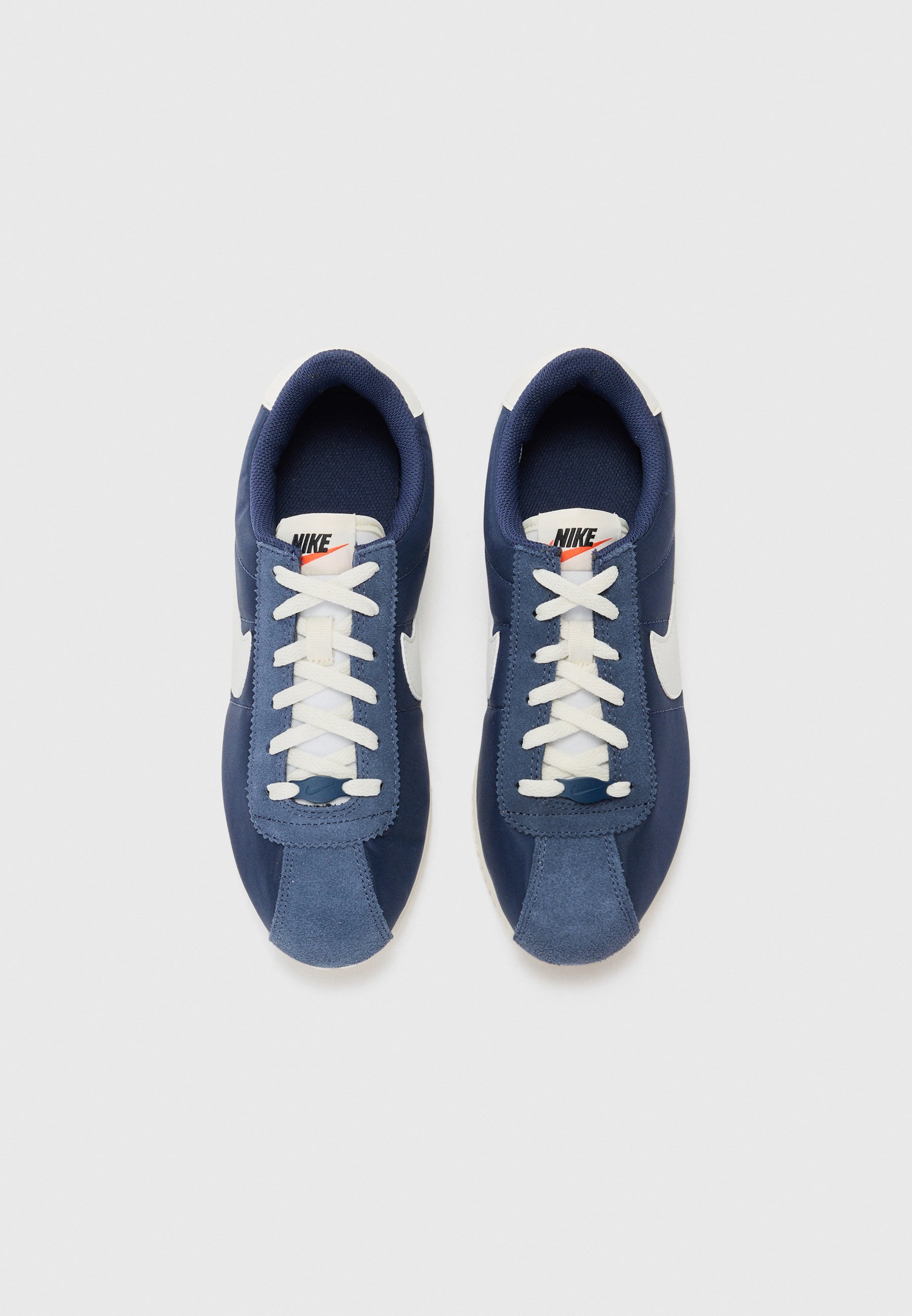navy blue and white nike cortez