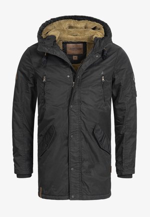 Black outerwear jacket with a hood, featuring a textured tan lining, zippers, snap buttons, and multiple pockets, designed for warmth.
