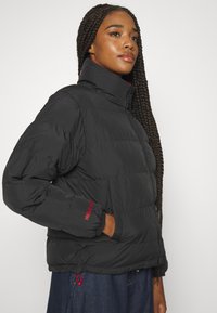 Helly Hansen REVERSIBLE PUFFER - Veste d'hiver - black