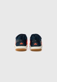 Navy and neon orange athletic shoes with mesh upper, padded collar, and gum rubber sole, featuring a logo on the heel and contrasting trim.