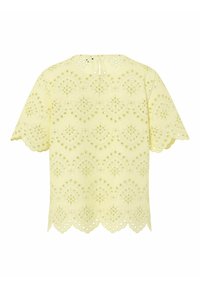 Blouse jaune clair à manches courtes avec broderie ajourée, bords festonnés et fermeture arrière avec bouton et boucle.