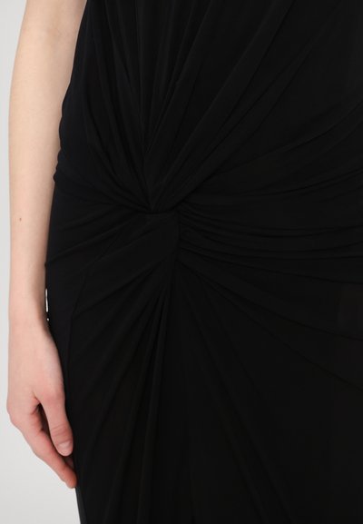 Vestido negro con un detalle de nudo retorcido en la cintura, con un tejido suave y drapeado y una textura lisa.
