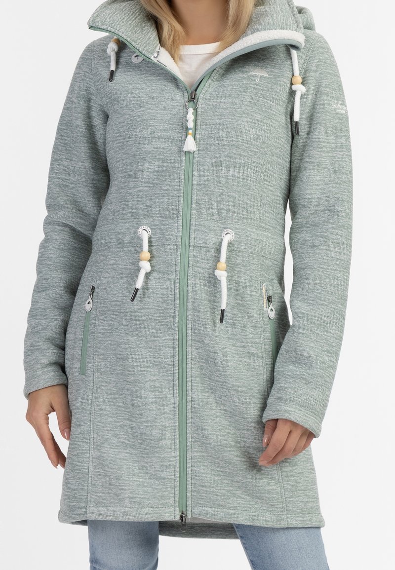 Ljusgrön, texturerad lång hoodie med dragkedja, snoddar och fickor. Har trädetaljer och en mjuk foder i huvan.