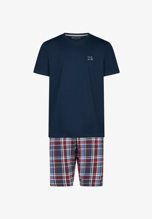 Navy blue short-sleeve T-shirt with small white logo on chest paired with red, white, and blue plaid shorts.