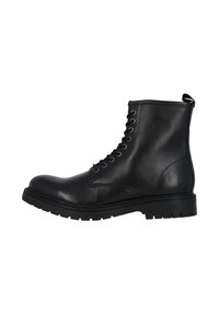 Bottine noire en cuir avec un laçage à l'avant, bout arrondi, semelle en caoutchouc robuste et une petite languette à l'arrière. Texture lisse avec des détails de design minimaux.
