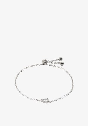 Srebrna bransoletka łańcuszkowa z centralnym kamieniem w kształcie gruszki, który jest przezroczysty. Posiada regulowany zapięcie z dwoma okrągłymi koralikami. Prosty i delikatny design.