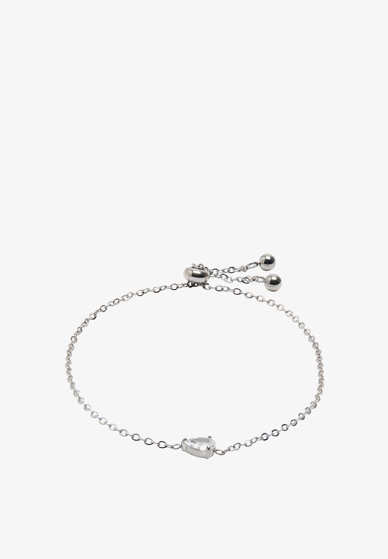 Srebrna bransoletka łańcuszkowa z centralnym kamieniem w kształcie gruszki, który jest przezroczysty. Posiada regulowany zapięcie z dwoma okrągłymi koralikami. Prosty i delikatny design.