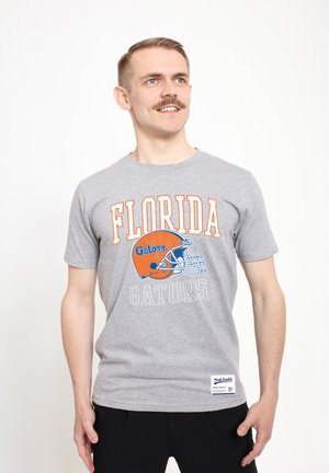 Šedé bavlněné tričko s potiskem "FLORIDA Gators" v oranžové a modré barvě, s grafikou fotbalové helmy. Krátké rukávy a kulatý výstřih.