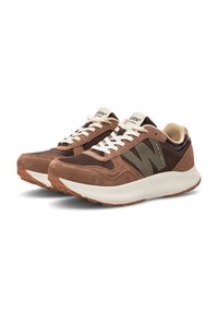 Brown suede sneakers with a textured finish, featuring white laces, a mesh lining, and a patterned accent on the side. Rubber sole.