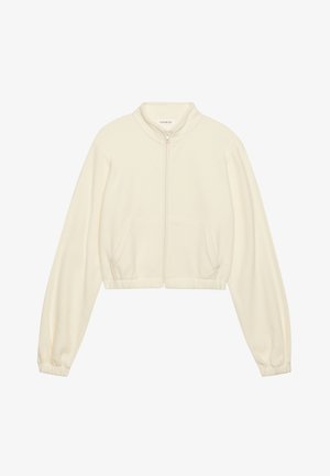 Lyhyt vetoketjullinen takki vaaleassa värissä, valmistettu pehmeästä kankaasta. Ominaisuuksiin kuuluvat pitkät hihat, kaksi etutaskua ja joustavat hihansuut tiiviin istuvuuden saavuttamiseksi.