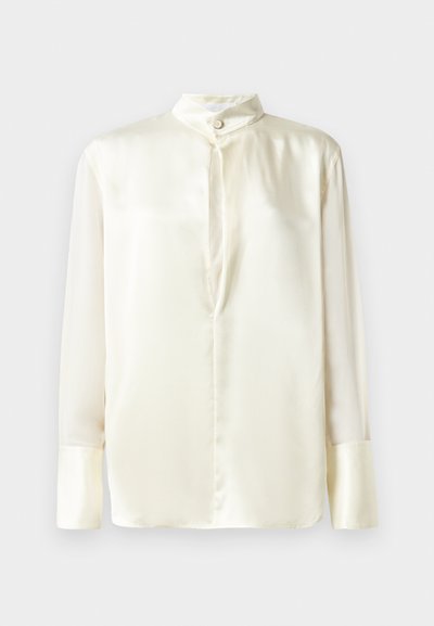 White silk blouse with long sleeves, stand collar, and a front button closure. Smooth texture and minimalist design without patterns.