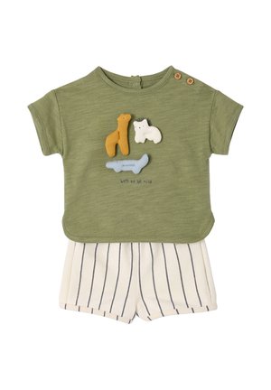 Green short-sleeve toddler shirt with three plush animals and "born to be wild" text, paired with white shorts with black vertical stripes.