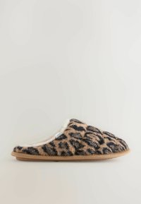 Leopard print slipper featuring a soft, textured beige and black upper, plush lining, and a durable beige sole. Casual slip-on design.