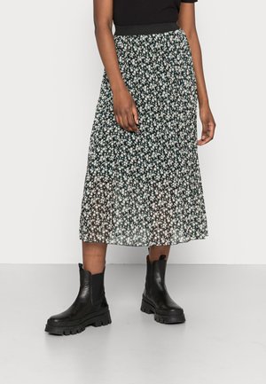 Floral midi skirt featuring a black background with white and pink flowers, pleated design, and an elastic waistband, paired with black ankle boots.