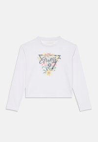 Weißes Langarm-Crop-Top mit grafischem Design, das farbenfrohe Blumenmuster und das Wort "Guess" in glitzerndem schwarzen Schriftzug zeigt.